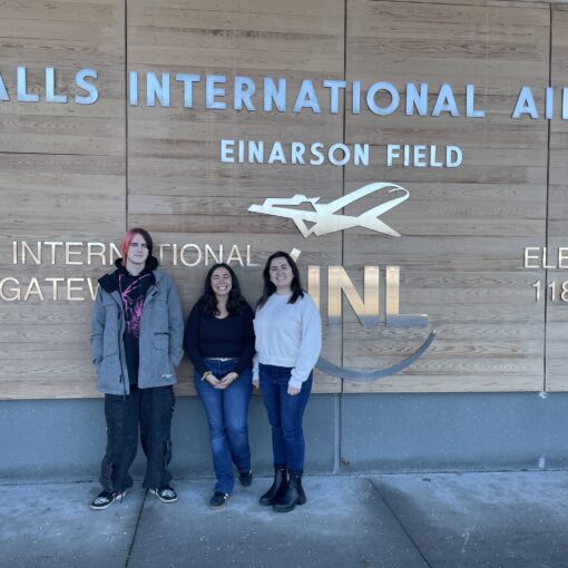 Three panelist in front of airport sign ready to provide prevention education.