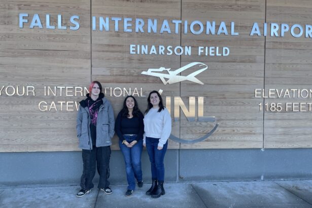 Three panelist in front of airport sign ready to provide prevention education.