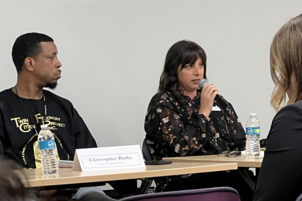 Megan at DOJ speaking on a microphone during a panel presention