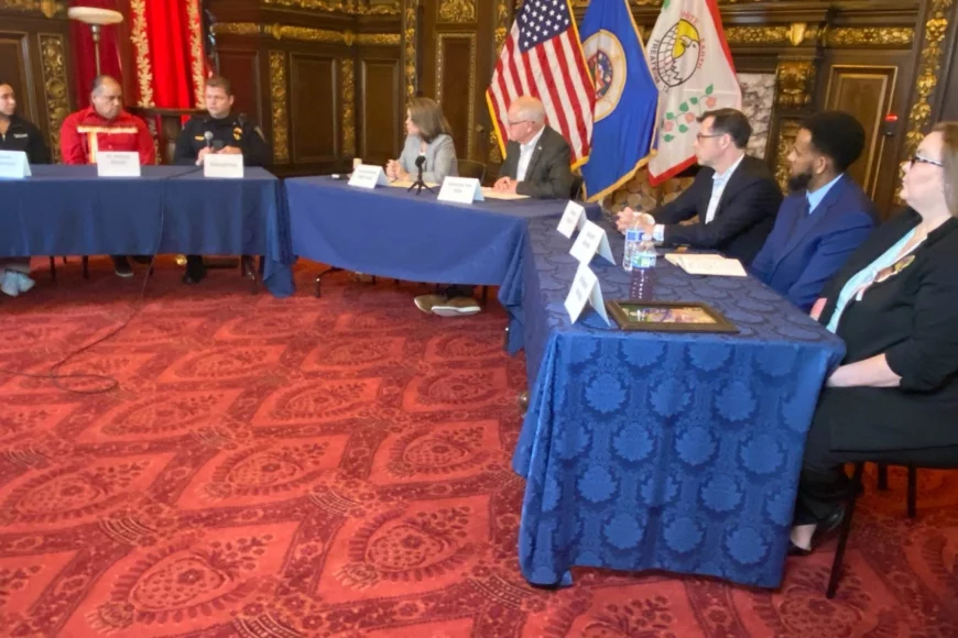 People sitting in a U-shaped table with Gov. Walz